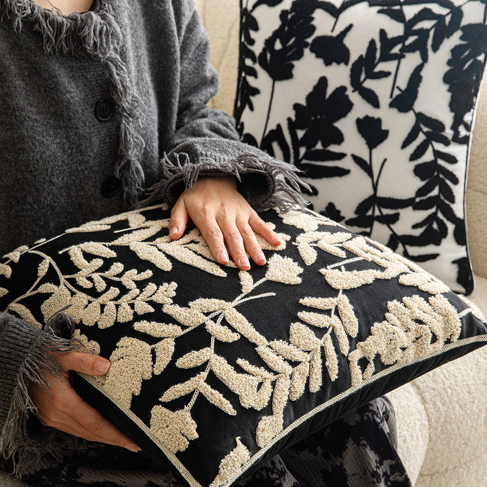 White embroidered floral pillowcases on black background