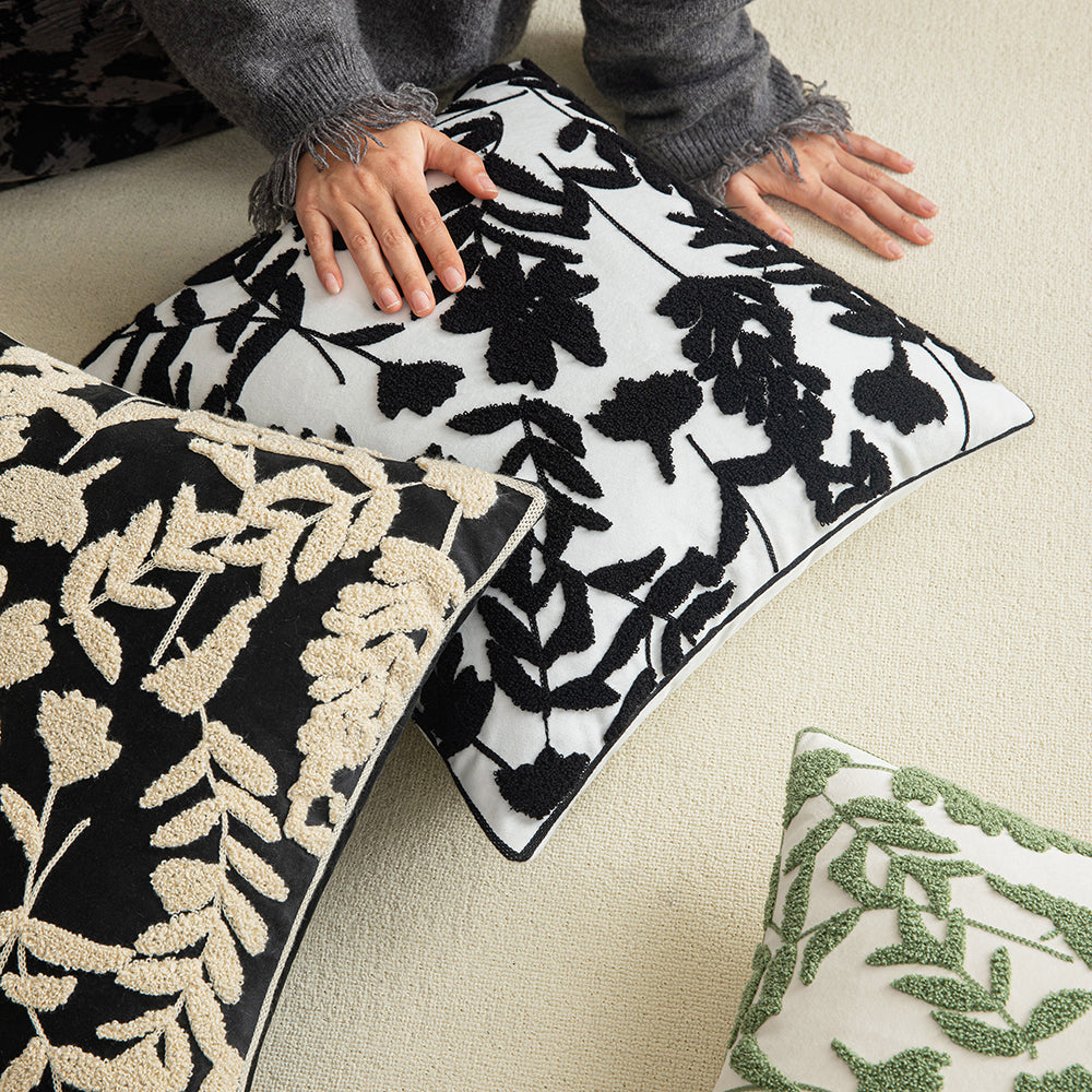 Black embroidered floral pillowcases on white background