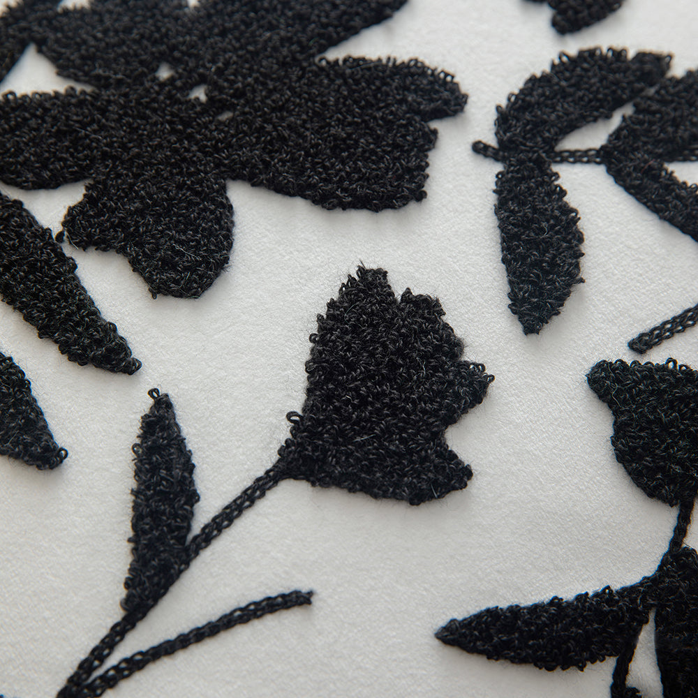 Black embroidered floral pillowcases on white background