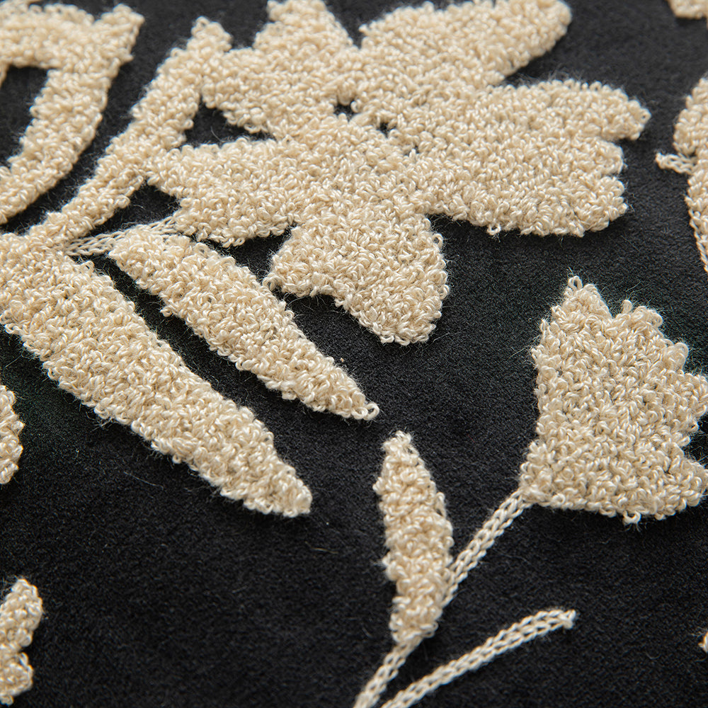 White embroidered floral pillowcases on black background
